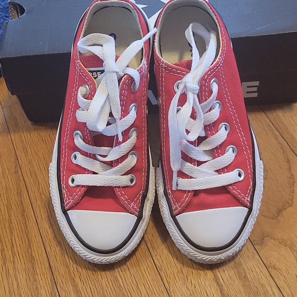 Red converse chuck taylors low top.